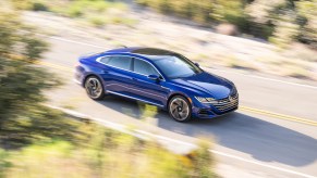 An overhead shot of a speeding blue Volkswagen Arteon. The last Volkswagen Arteon is going on sale for the 2024 model year.