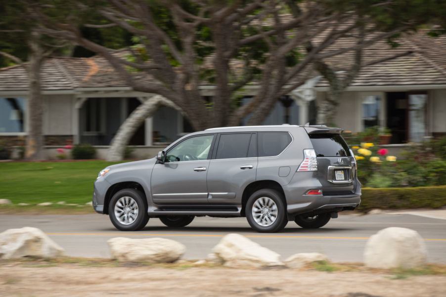 The Lexus GX luxury SUV driving in a neighborhood