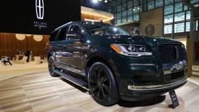 A black Lincoln Navigator on display at an auto show.