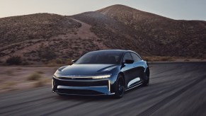 A dark blue Lucid Air Sapphire on a desert road. The Lucid Air Sapphire's price isn't for the faint-hearted.