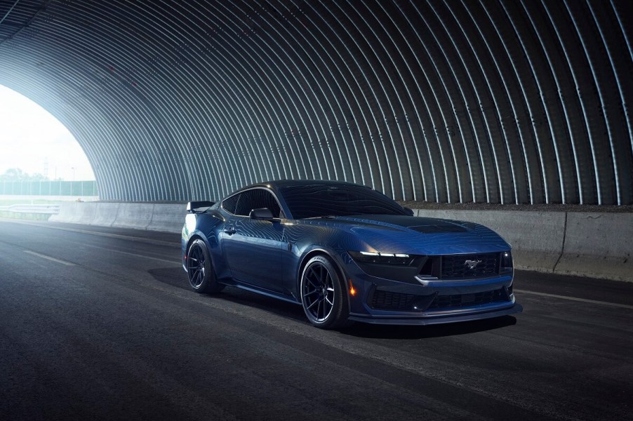 A Dark Ember Metallic Blue 2024 Ford Mustang Dark Horse shows off its new S650 styling in a tunnel.