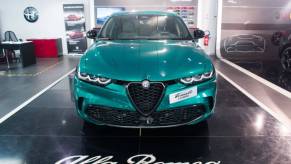 A blue Alfa Romeo Tonale on display at an auto show.