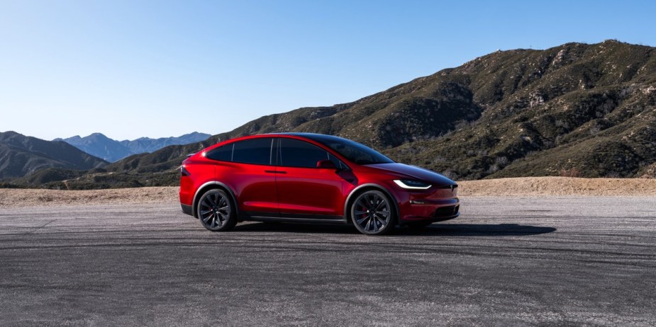 A red Tesla Model X (Tesla's most expensive SUV) is parked