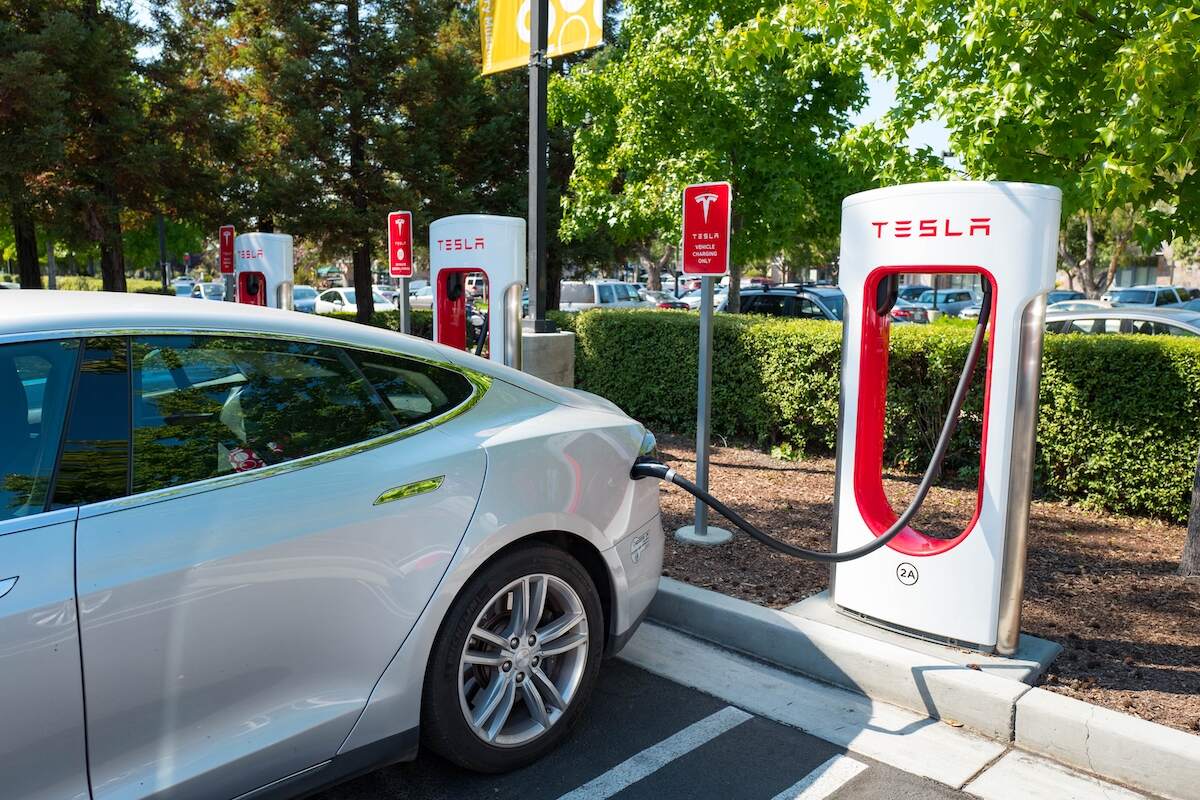 A Tesla EV charges at a Tesla Supercharger