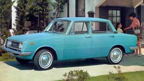 A blue Toyota Corona parked in a driveway.