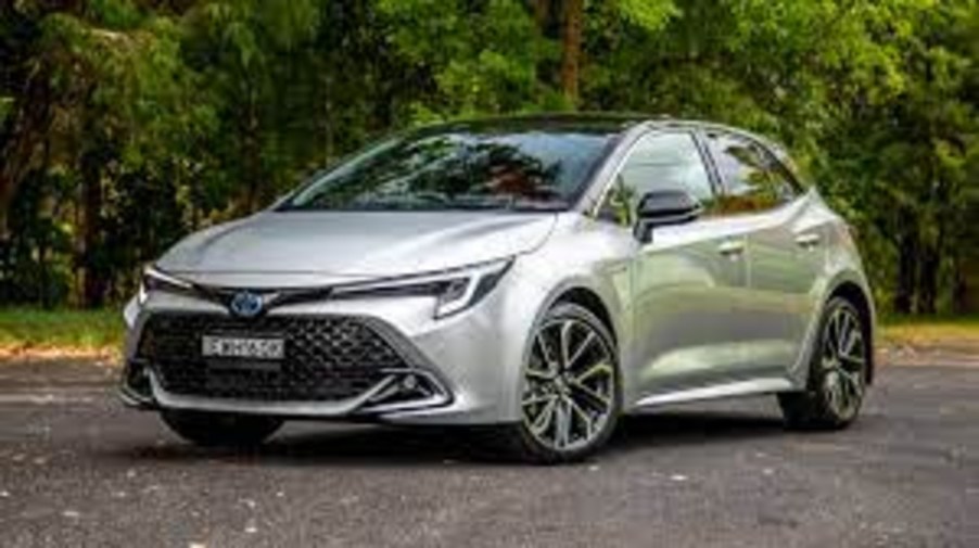 Silver 2023 Toyota Corolla sedan with trees in background