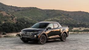 A 2024 Hyundai Santa Cruz XRT compact pickup truck model parked on a dirt gravel plain