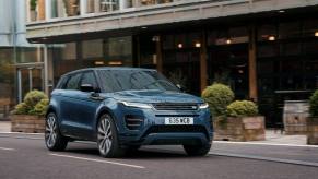 A 2024 Land Rover Range Rover Evoque Autobiography subcompact luxury SUV model driving past cafes