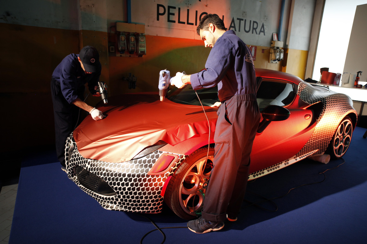 Car wrappers wrap a car using heat guns.