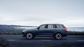 A side profile shot of a Volvo XC90 Recharge T8 with AWD midsize luxury plug-in hybrid SUV model