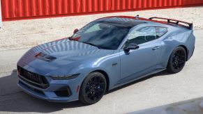 2024 Ford Mustang S650 parked next to shipping containers