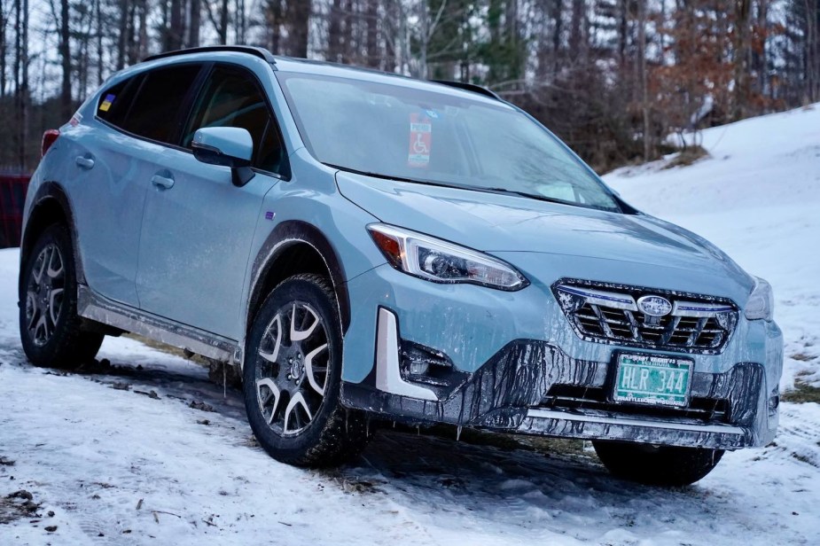 Cool khaki colored Subaru car parked on a snowy driveway.