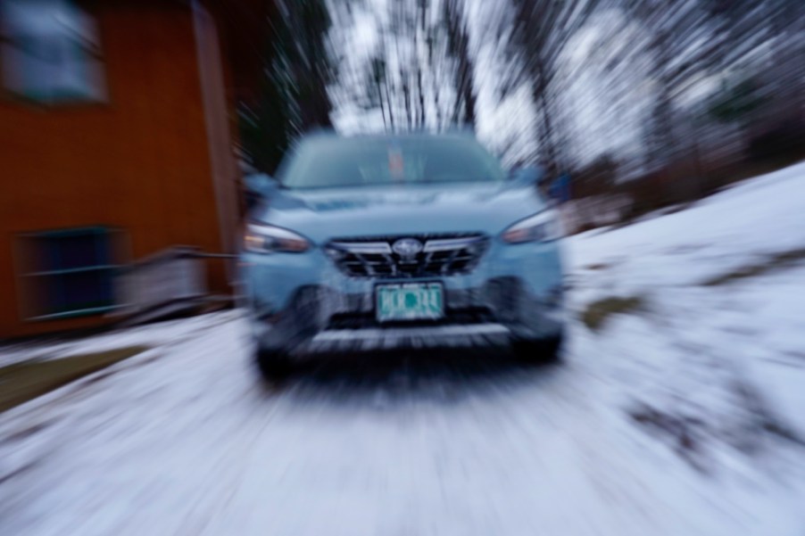 The grille of a cool Khaki colored Subaru crosstek car, the background blurry.