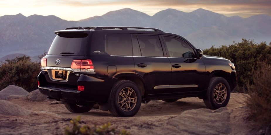 A black 2021 Toyota Land Cruiser full-size SUV is parked off-road, it's wildly dependable.