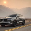 A 2023 Acura RDX driving down an open road.