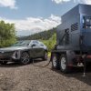 A gray 2023 Cadillac Lyriq charging with a mobile generator. While not necessarily a top contender, the Cadillac Lyriq value shouldn't be underestimated.