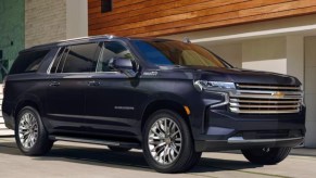 A black 2023 Chevrolet Suburban full-size SUV is parked.