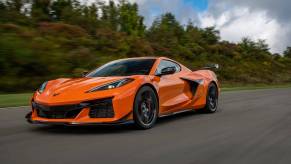 A bright-orange 2023 Chevrolet Corvette Z06 cruises down a track.