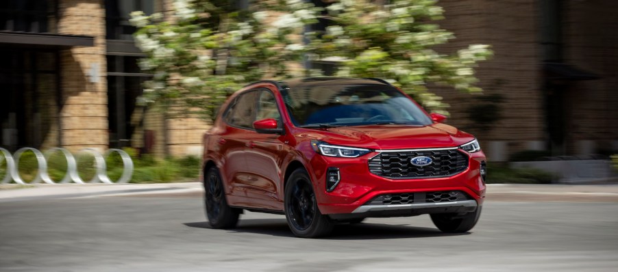 2023 Ford Escape in red driving in the city. Ford Escape owners would like to see some changes.