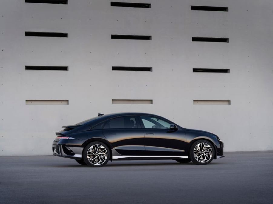 A black 2023 Hyundai EV, the IONIQ 6, shows off its slippery shape, which establishes it as one of the most efficient electric cars.