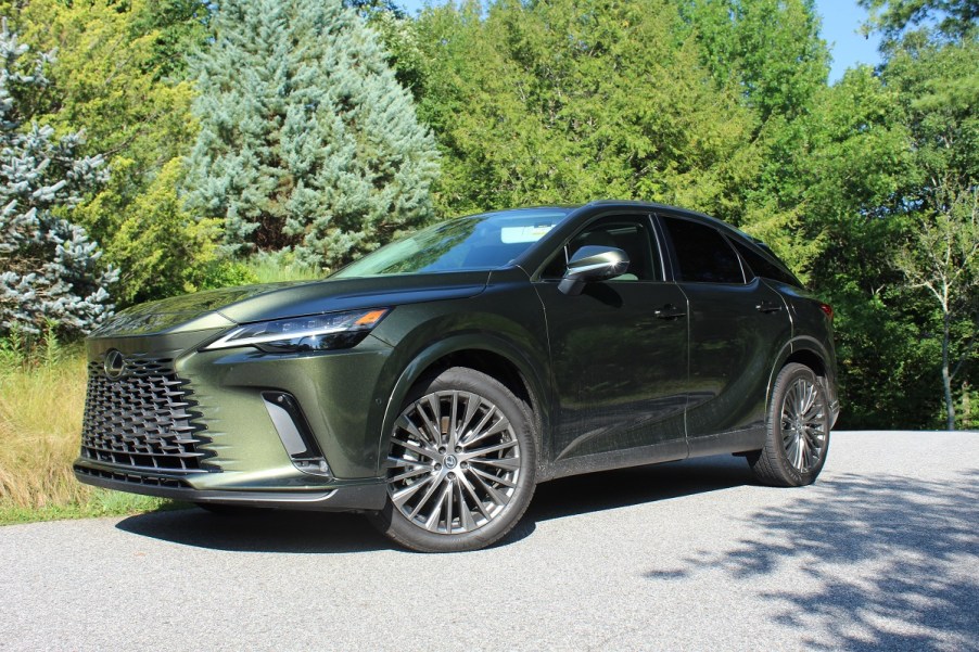 The 2023 Lexus RX 350h parked near foliage