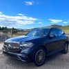 A front corner view of the 2023 Mercedes-Benz GLC 300 by a mountain