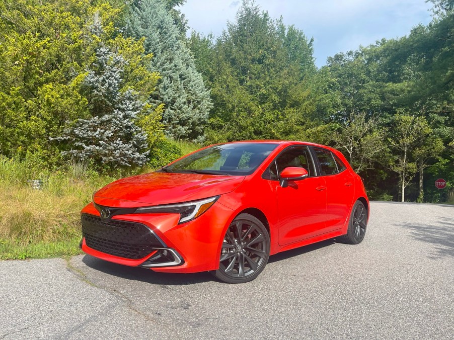 The 2023 Toyota Corolla Hatchback parked near foliage