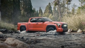 The 2023 Toyota Tundra off-roading through a stream