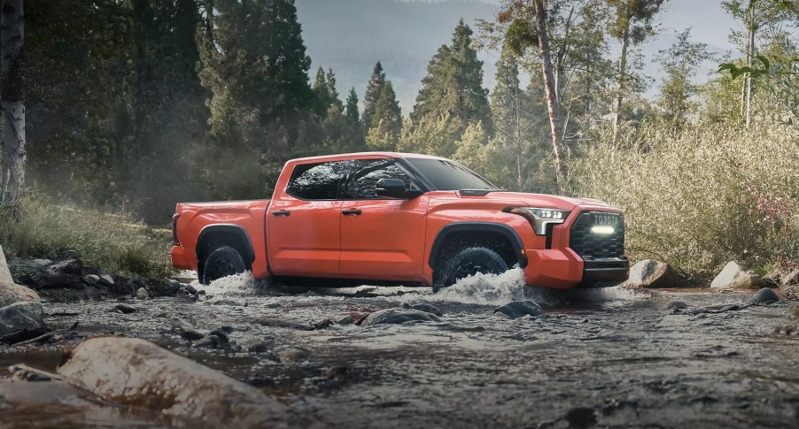 The 2023 Toyota Tundra off-roading through a stream