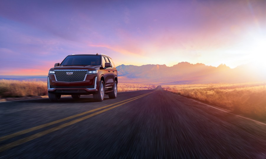 2024 Cadillac Escalade Premium Luxury in Mahogany Metallic on highway. Cadillac Escalade sales are on the rise