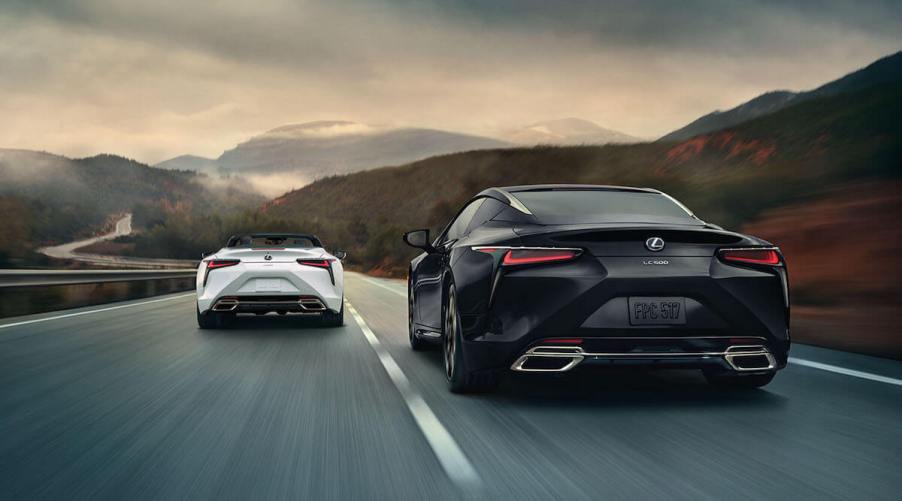 A pair of Lexus LC 500s driving down a road