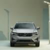 A front-facing 2024 Volvo XC40 subcompact luxury SUV model illuminated under a streetlight lamppost