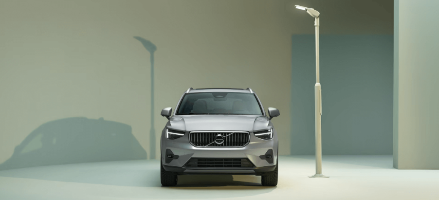 A front-facing 2024 Volvo XC40 subcompact luxury SUV model illuminated under a streetlight lamppost