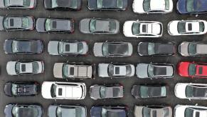 A birds-eye view of new cars at a dealership.