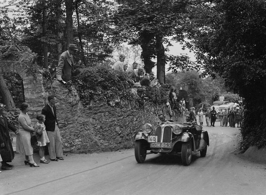 A black and white photo of the first BMW car at a race.