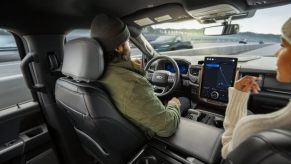 A man uses Ford's BlueCruise on the highway