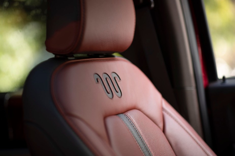 King Ranch "Running W" logo on the leather seat of a Ford truck.