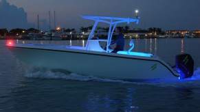 A white Forza X1 F-22 electric center console boat in a marina