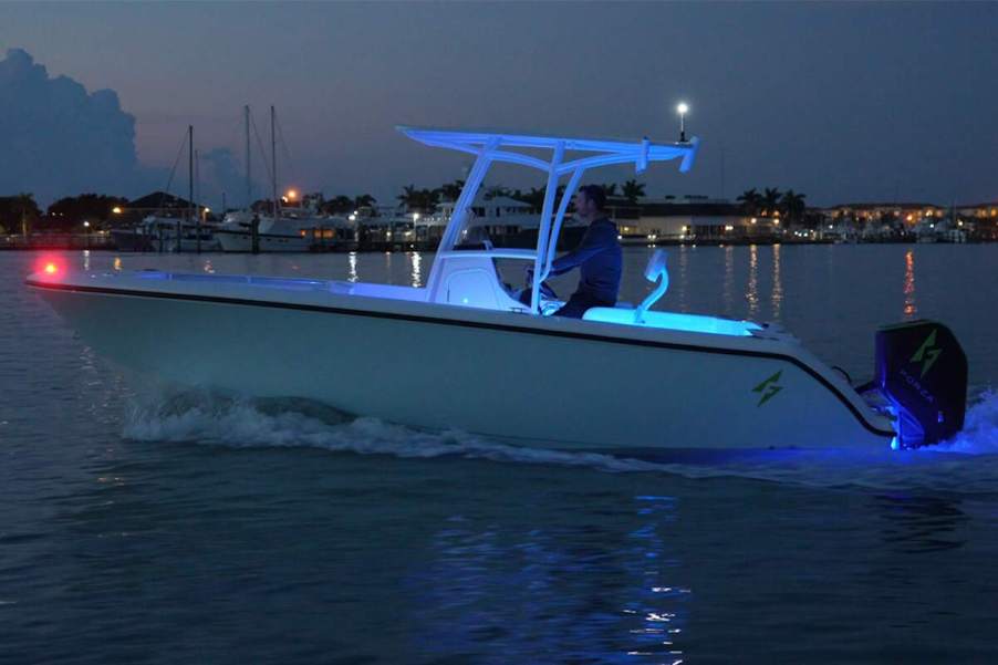 A white Forza X1 F-22 electric center console boat in a marina