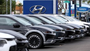 Hyundai cars at dealership with Hyundai logo in background