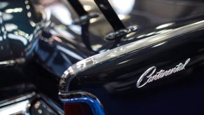 A dark Lincoln Continental displays its model badge.