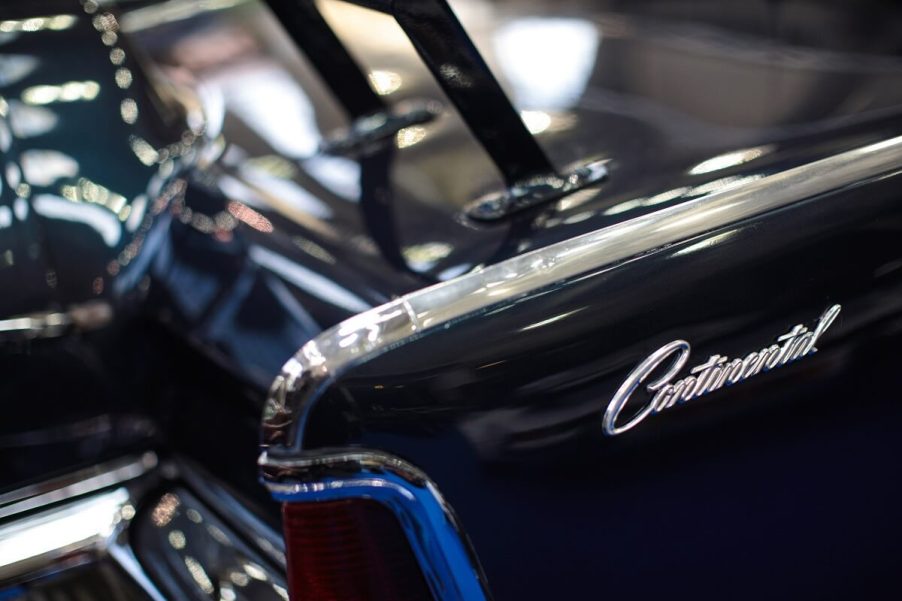 A dark Lincoln Continental displays its model badge.