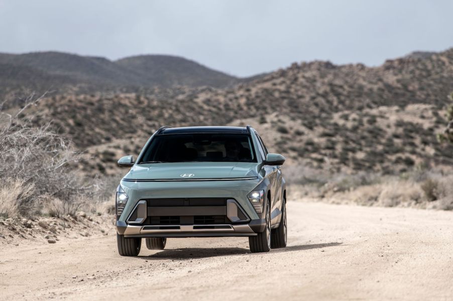 A green 2024 Hyundai Konda on a desert road. The Hyundai Kona and Venue are closely linked