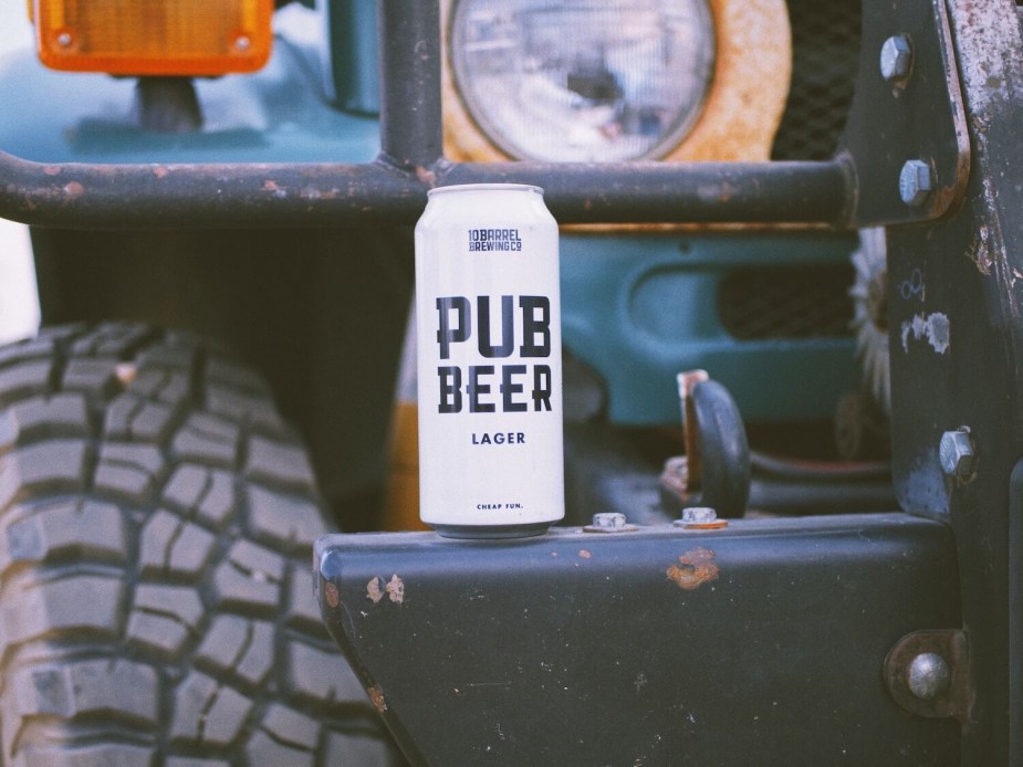 A land cruiser FJ40 bumper wiht a can of beer set atop it.