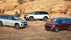 Three Jeep Grand Cherokee midsize SUVs are parked.