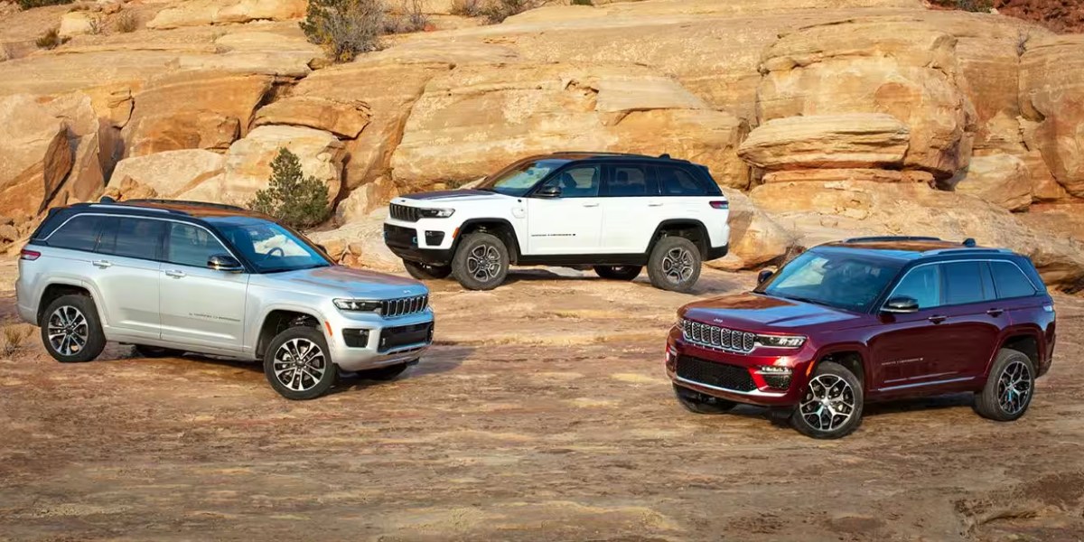 Three Jeep Grand Cherokee midsize SUVs are parked.