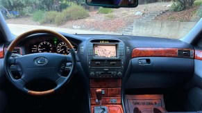 Interior of a 2004 Lexus LS430 affordable luxury car displaying black leather interior and infotainment system with GPS navigation