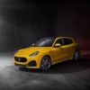 A yellow Maserati Grecale Trofeo on display against a gray backdrop. The Maserati Grecale's price is a huge barrier to entry.