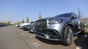 A Mercedes-Benz AG GLE SUV and other new and used automobiles in a customer collection parking lot at a Daimler AG showroom. The Mercedes-Benz GLE price makes it a better choice than the Maserati Levante.