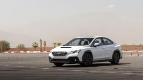 A white 2023 Subaru WRX parked on a track. Subaru sales across all major models are improved in 2023